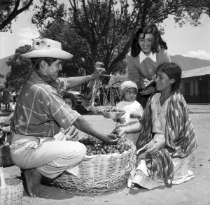 The Institute of Nutrition of Central America and Panama (INCAP), with its main offices in Guatemala City, has been engaged since 1949 in studying human nutrition and finding solutions to the problems of malnutrition. INCAP’s field staff carried out numerous surveys, which included staying with a family for seven days and recording the food purchases made by the housewife, observing the preparation and consumption of food, and recording the intake of each member of the family. Here, a Guatemalan indigenous woman (right) purchases plums from a vendor in a marketplace. Accompanying her is a member of INCAP’s nursing staff, who records the purchases. The photographic documentation became part of INCAP’s efforts in research, education, and global communication. (United Nations Photo 7447495, photographer unknown, 1955) The Institute of Nutrition of Central America and Panama (INCAP), with its main offices in Guatemala City, has been engaged since 1949 in studying human nutrition and finding solutions to the problems of malnutrition. INCAP’s field staff carried out numerous surveys, which included staying with a family for seven days and recording the food purchases made by the housewife, observing the preparation and consumption of food, and recording the intake of each member of the family. Here, a Guatemalan indigenous woman (right) purchases plums from a vendor in a marketplace. Accompanying her is a member of INCAP’s nursing staff, who records the purchases. The photographic documentation became part of INCAP’s efforts in research, education, and global communication. (United Nations Photo 7447495, photographer unknown, 1955)