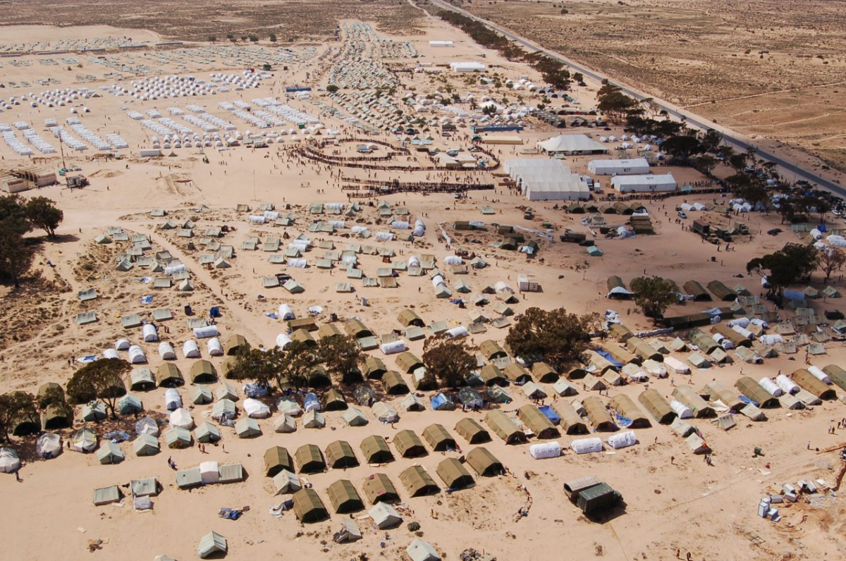 Tunesisch-libysche Grenze, 2011: Das Camp Choucha in der tunesischen Wüste wird zum zentralen Aushandlungsort von Flüchtlingsrechten und zum Symbol des migrantischen Widerstandes im post-revolutionären Tunesien. (Wikimedia Commons, Tab59 from Düsseldorf, Allemagne, CampChouchaTunisie 2, CC BY-SA 2.0) Tunesisch-libysche Grenze, 2011: Das Camp Choucha in der tunesischen Wüste wird zum zentralen Aushandlungsort von Flüchtlingsrechten und zum Symbol des migrantischen Widerstandes im post-revolutionären Tunesien. (Wikimedia Commons, Tab59 from Düsseldorf, Allemagne, CampChouchaTunisie 2, CC BY-SA 2.0)